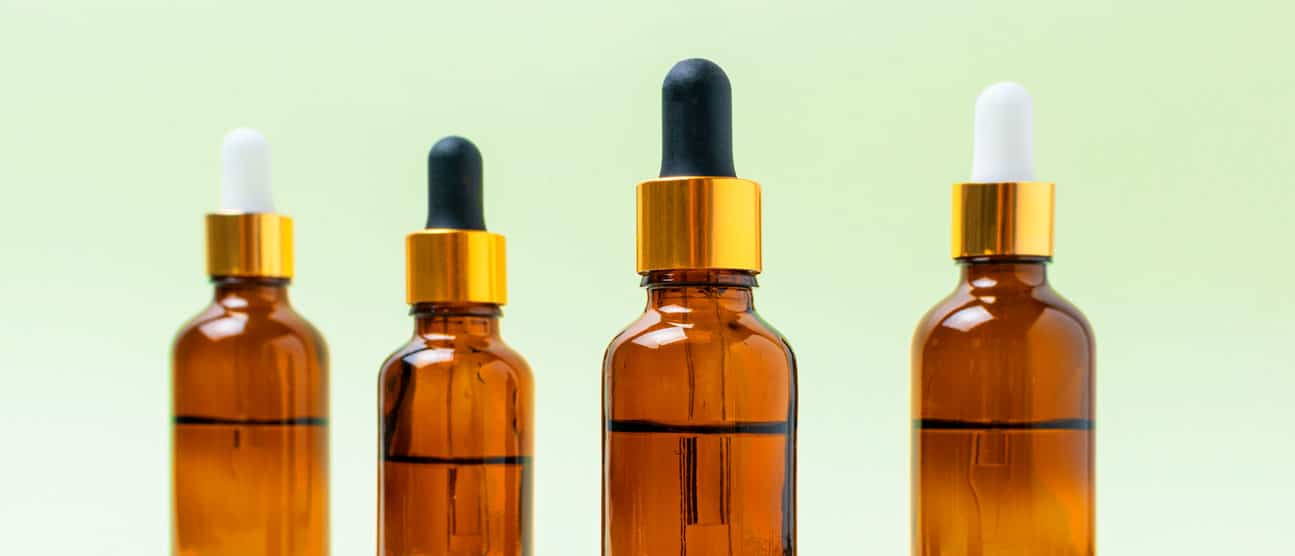 Four Boston round oil dropper bottles in various sizes.