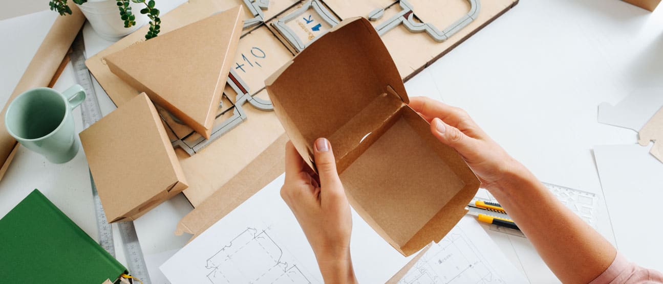 person choosing from selection of packaging types
