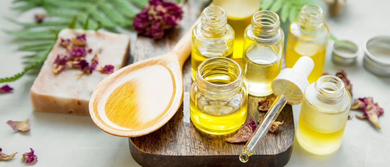 An assortment of different essential oil products in glass dropper bottles.