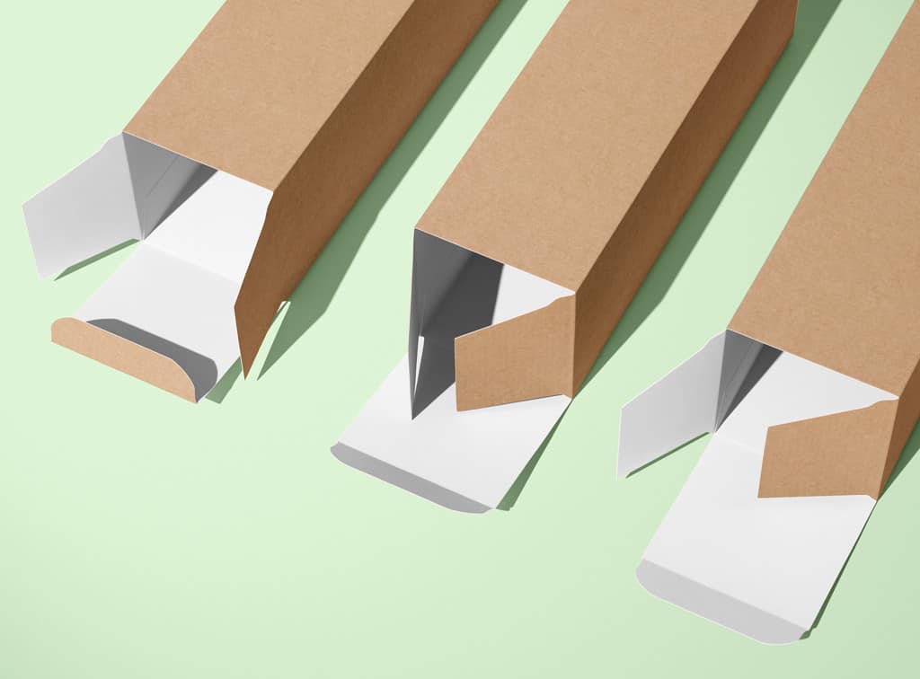 Three Kraft straight tuck boxes on a green background.