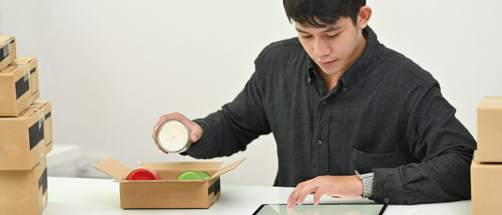 person packing candle into box