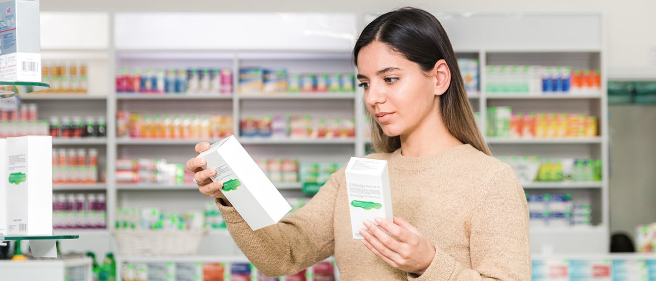 woman looking at supplement boxes
