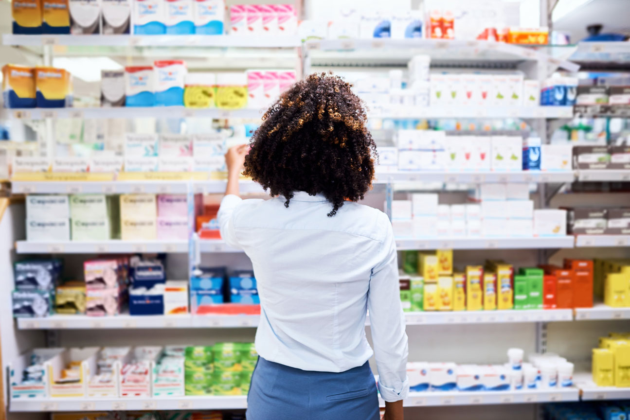woman shopping in store looking at products on a shelf