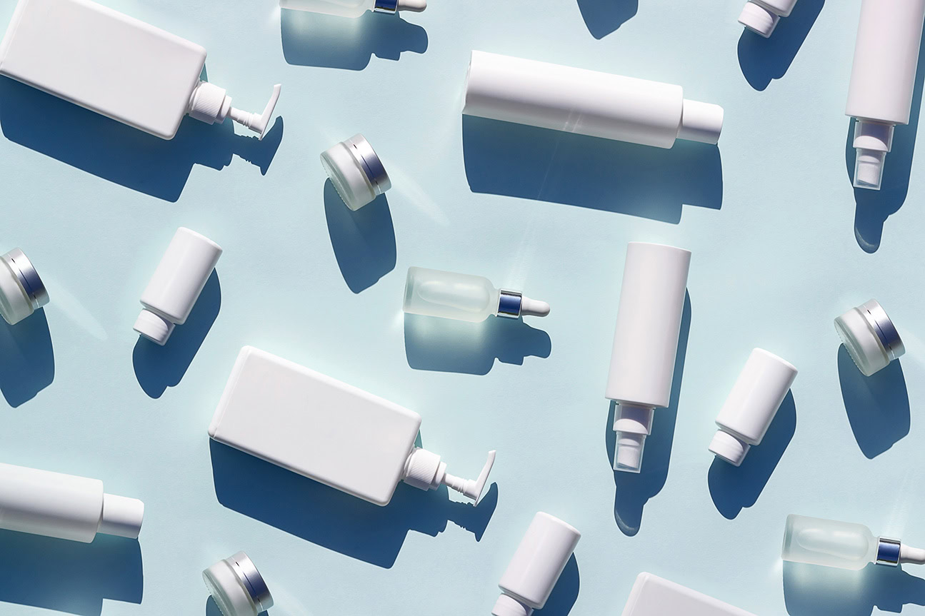 various cosmetics bottles on a light blue background